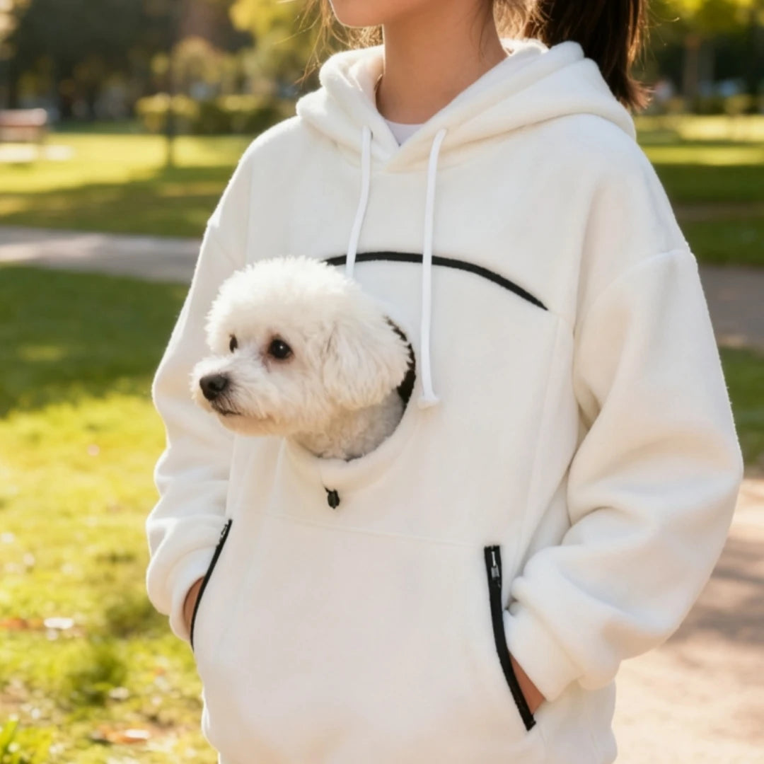 Woman wearing a white pet pouch hoodie with a small white dog in the front pocket