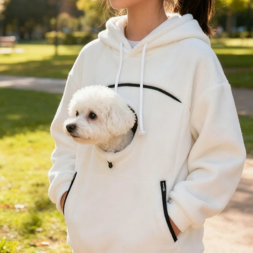 Woman wearing a white pet pouch hoodie with a small white dog in the front pocket
