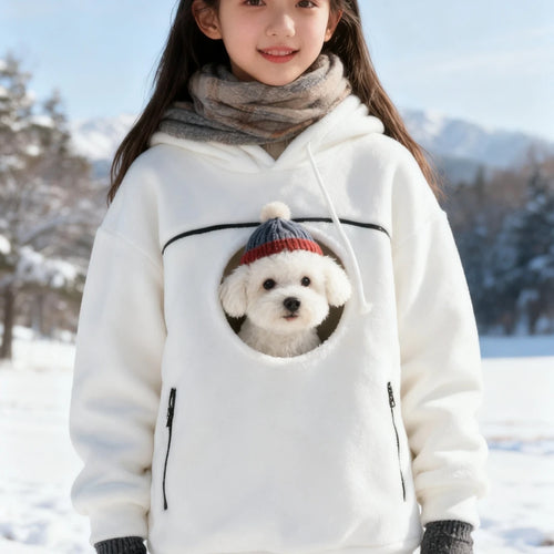 White pet pouch hoodie with a puppy peeking out on a snowy day